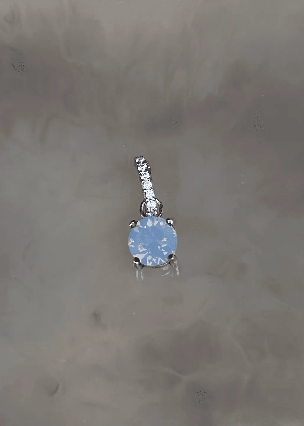 Dije en Plata 925 con cristal Swarovski color azul opalo y zirconia
